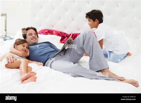 Father And Children Relaxing In Bed Together Stock Photo Alamy
