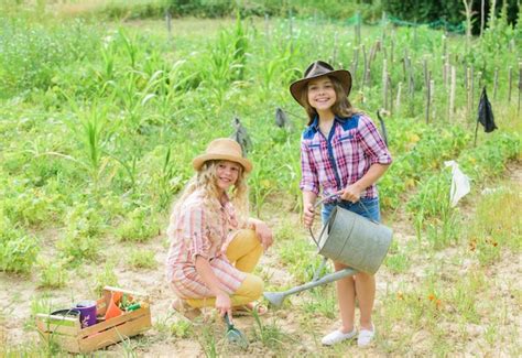 Premium Photo Sisters Together Helping At Farm Girls Planting Plants