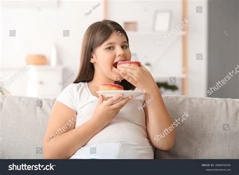 Стоковая фотография 2088792541 Overweight Girl Eating Unhealthy