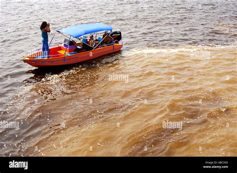 Meeting Of The Waters At The Confluence Of The Amazonas River Brown