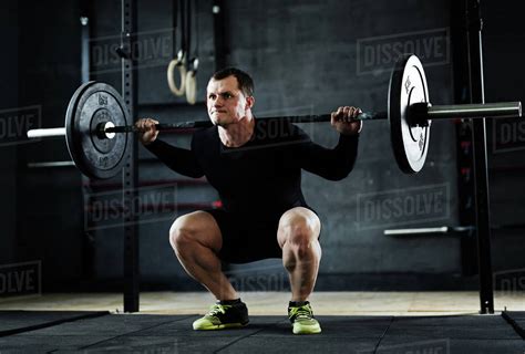 Active Man Lifting Weight During Workout In Gym Stock Photo Dissolve