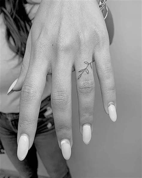A Womans Hand With A Small Tattoo On It