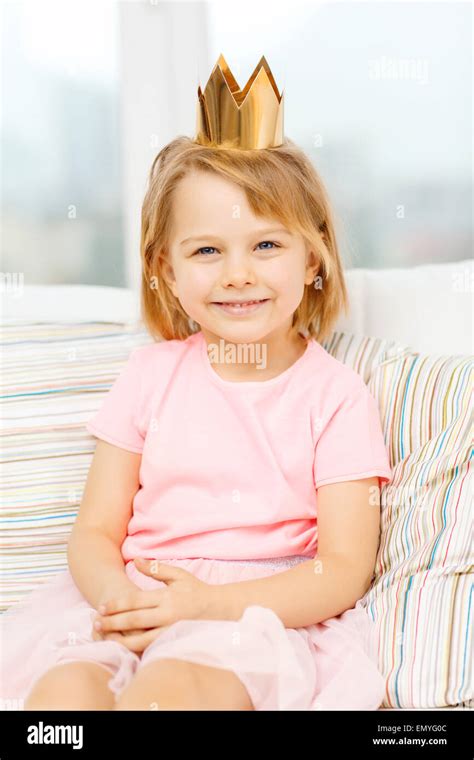 Smiling Little Girl In Crown Sitting On Sofa Stock Photo Alamy