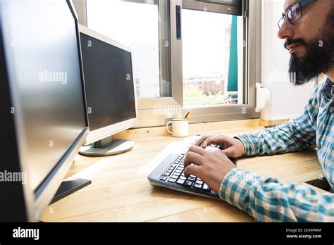 Man Typing At Work On A Computer High Resolution Stock Photography And