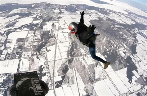 Skydiving Over A Snow Covered Landscape Adventure Bound
