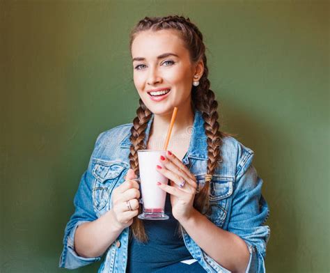 Beautiful Girl With Braids Sitting In A Cafe And Drinking A Milkshake