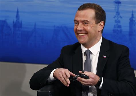 Russian Prime Minister Dmitry Medvedev Smiles As He Attends At The