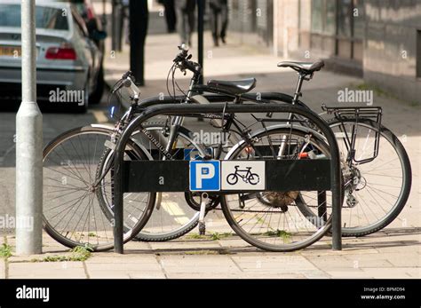 Two Bicycles Are Chained Up To City Centre Cycle Parking Stock Photo