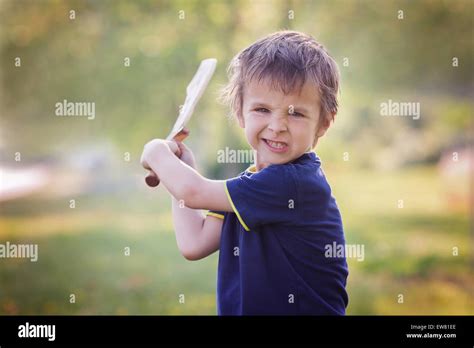 Angry Little Boy Holding Sword Glaring With A Mad Face At The Camera