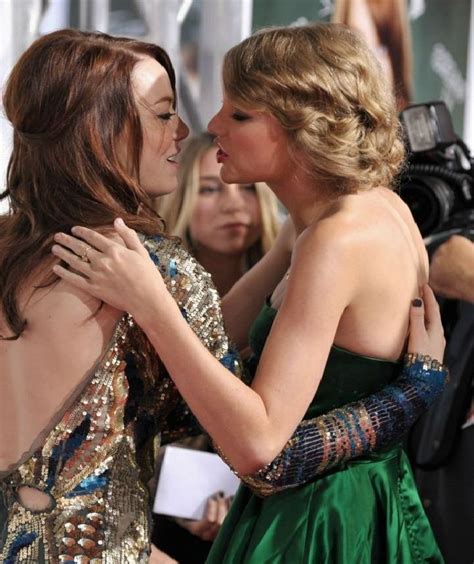 Two Beautiful Women Hugging Each Other On The Red Carpet