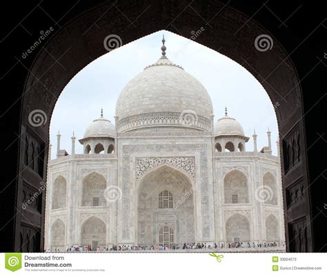 Taj Mahal Medieval White Marble Mausoleum At Sunrise With Moody Sky At