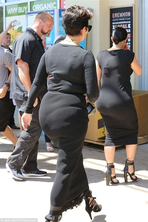 Two Women In Black Dresses Are Walking Down The Street With One Womans
