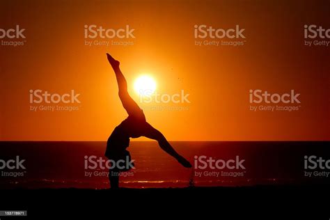 Gymnast Girl Makes Handstand On Beach In Sunset Stock Photo Download