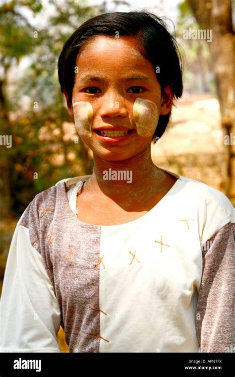 A Young Burmese Village Girl Poses For A Portrait Wearing The Iconic