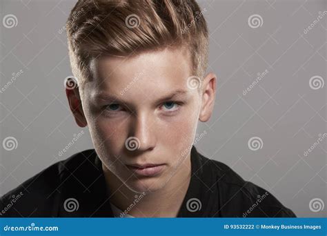 White Teenage Boy Looking Up To Camera Head And Shoulders Stock Photo