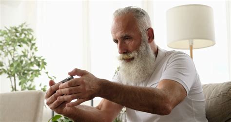 Old Man Playing Game Using Mobile Phone At Stock Footage Sbv