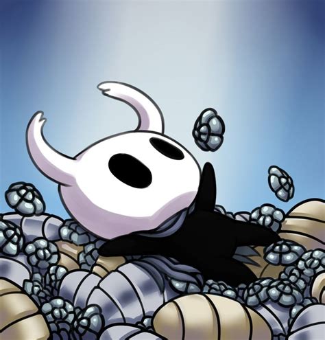 A Black And White Cat Laying On Top Of A Pile Of Silver Balls In Front