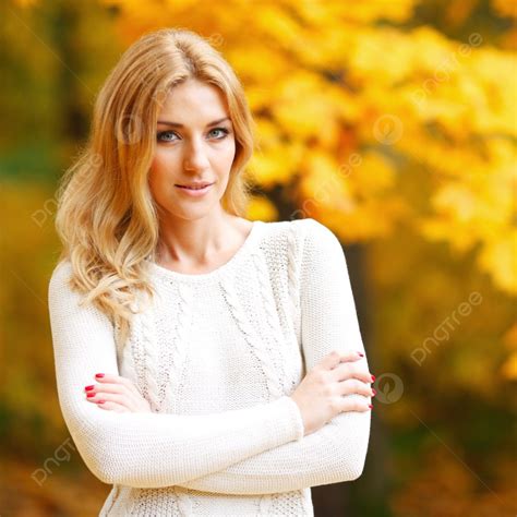 Happy Woman Posing In Autumn Park On Yellow Trees Background And