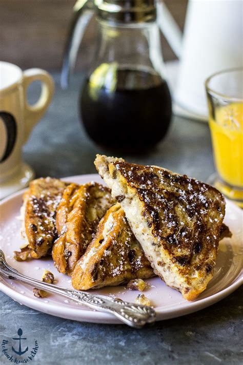 Three pieces of french toast with strawberry topping and powdered sugar. Walnut Cinnamon Cream Cheese Stuffed French Toast | The ...