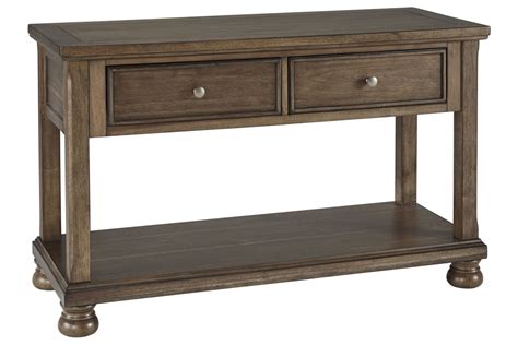 Tobacco brown finish allows the natural grain of the acacia veneers to show through in an organic way. Flynnter Console Sofa Table by Ashley at Gardner-White