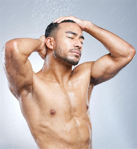 Premium Photo Man In Shower With Blue Background Cleaning And