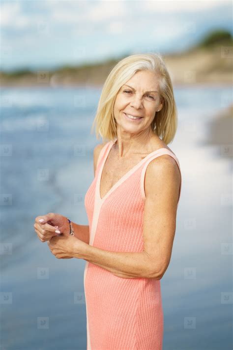 Mature Woman On Shore Of A Beach Elderly Female Enjoying Her