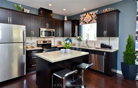 For example, you may be using a while it is certainly possible to pair dark countertops with deeply stained cabinets, the combination of light and dark seem to give the kitchen more visual. granite countertops. dark cabinets. stainless steel ...