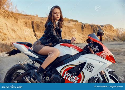 Teen Girl Sitting On A Racing Motorcycle Beautiful Biker In A Short