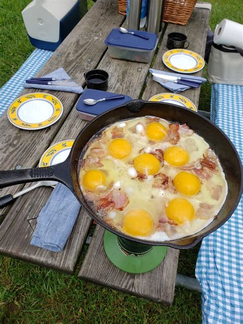 Picnic Table With A Frying Pan Cooking Bacon And Eggs Stock Image