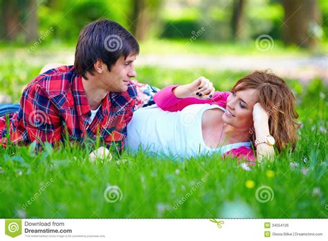 Beautiful Couple Lying In Spring Grass Royalty Free Stock