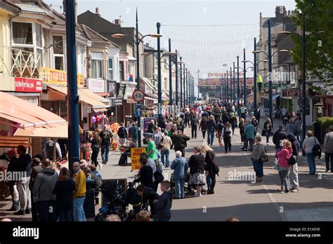 shoppers on great yarmouth s popular regent road lined with t shops and other traditional
