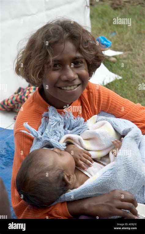 Young Aboriginal Girl Holds Baby Wrapped In A Blanket Stock Photo Alamy