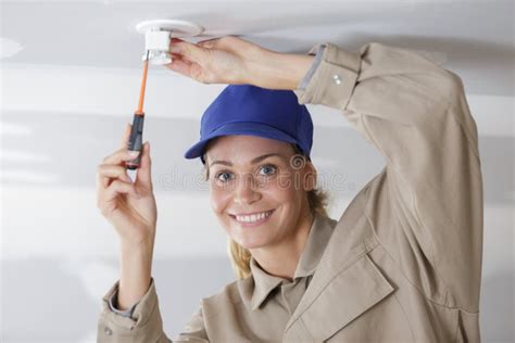 Woman Installing Light Bulb In Ceiling Stock Image Image Of Home
