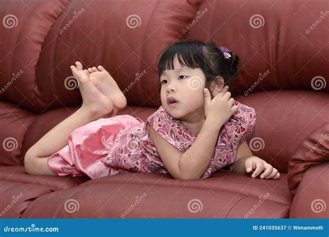 Portrait Cute Little Asian Girl Lying On The Sofa At Home Stock Image Image Of Asian Comfort