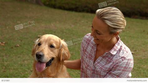 Happy Blonde Woman With Her Dog In The Park Stock Video Footage 8131881