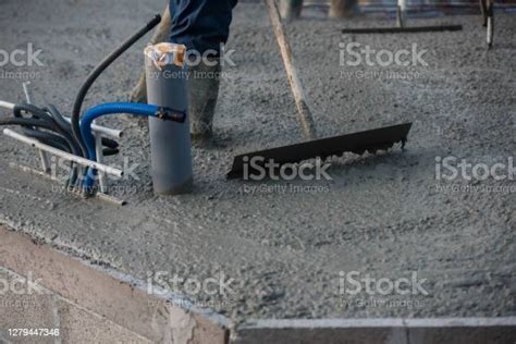 Worker Spreading Concrete On Construction Site Stock Photo Download