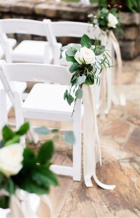 Floral Bunches And Simple Ribbon Detail On Folding Chairs For Ceremony