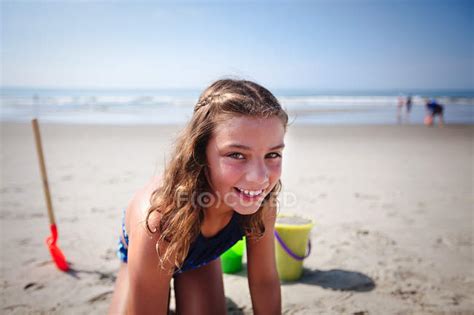 Portrait Of Girl Playing On Sandy Beach Travel Leisure Stock Photo