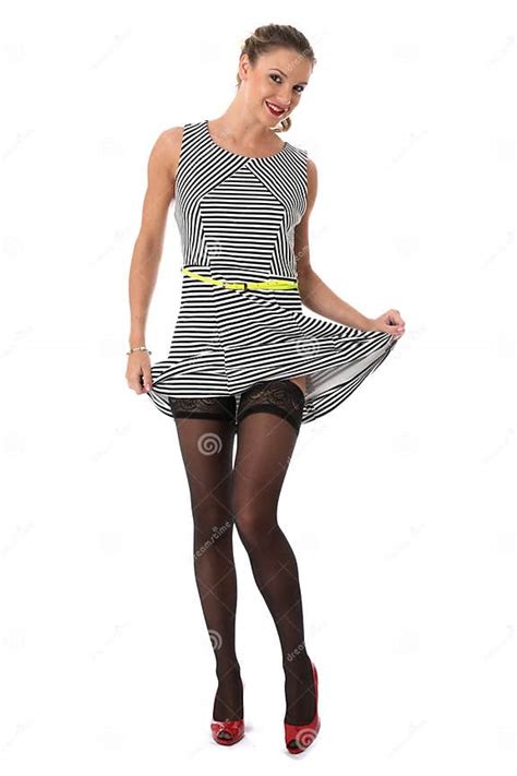 Cheeky Young Woman Raising Skirt Showing Stocking Tops Stock Image Image Of Showing Stocking