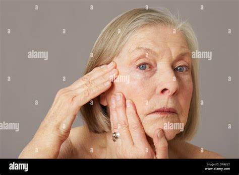 Senior Woman Touching Face Stock Photo Alamy