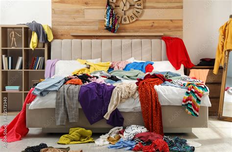 Pile Of Clothes On Bed In Messy Room Fast Fashion Concept Stock Photo