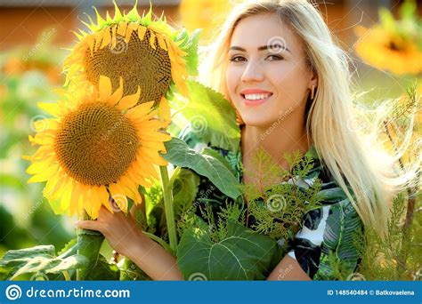 Beautiful Young Woman Posing Near Sun Flowers Summer Portrait At The