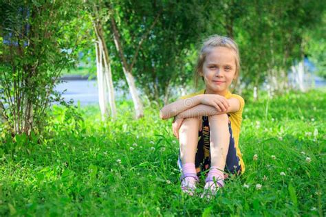 Little Girl Sitting In The Grass Stock Image Image Of Blond Girl