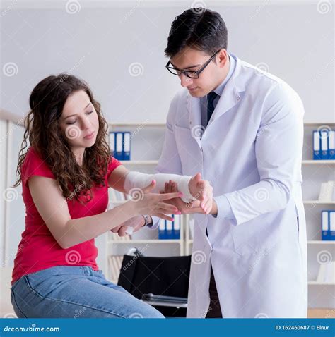 Doctor And Patient During Check Up For Injury In Hospital Stock Image