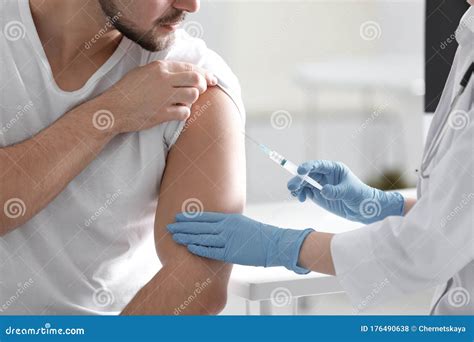 Doctor Giving Injection To Patient In Hospital Vaccination Concept