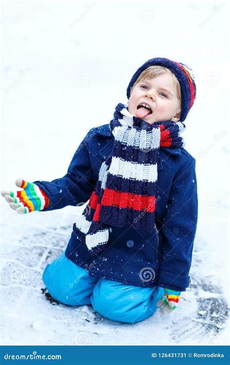 Cute Little Funny Kid Boy In Colorful Winter Fashion Clothes Having Fun