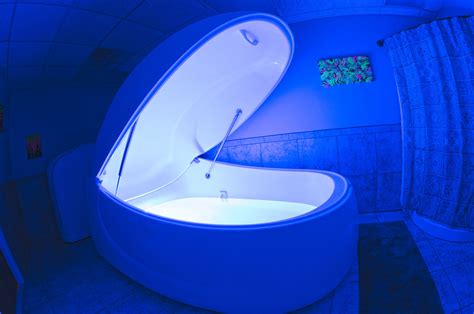 A Bathtub In The Middle Of A Room With Blue Lighting