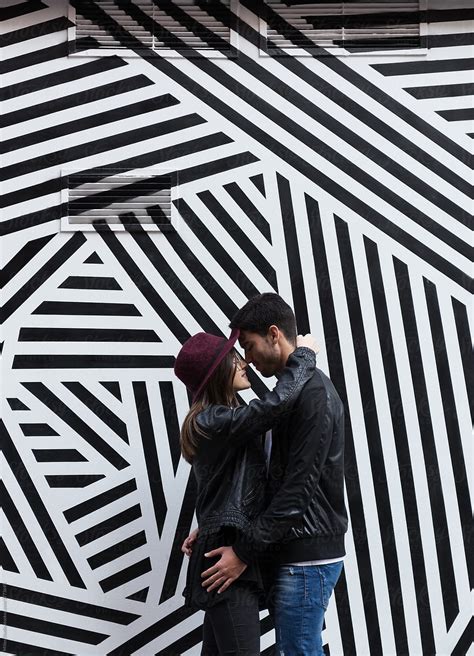 Trendy Kissing Couple Against Wall By Stocksy Contributor Milles Studio Stocksy