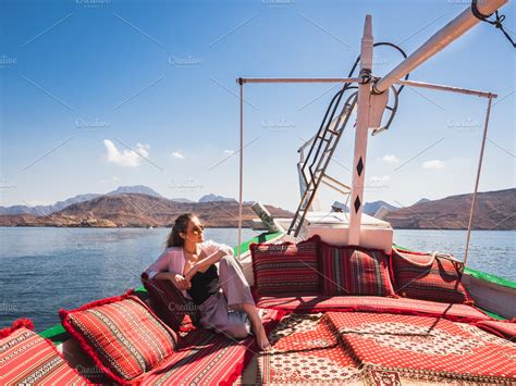 fashionable woman sitting in a boat ~ nature photos ~ creative market