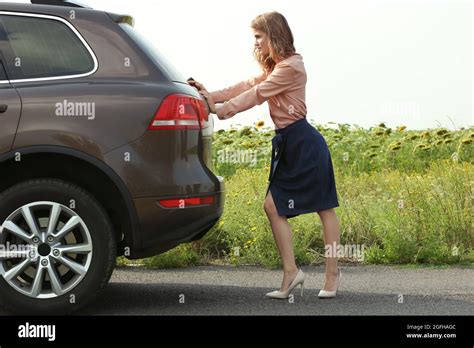 Pretty Young Woman Pushing Car Stock Photo Alamy